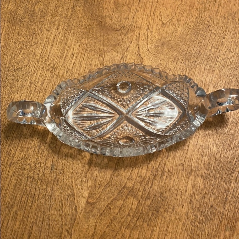 Crystal dish with rounded handle on the ends beautifully etched